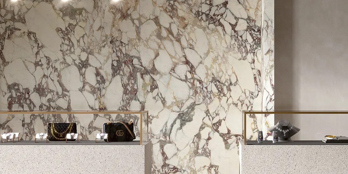Large format glazed satin white sintered stone wall application with purple marble veining