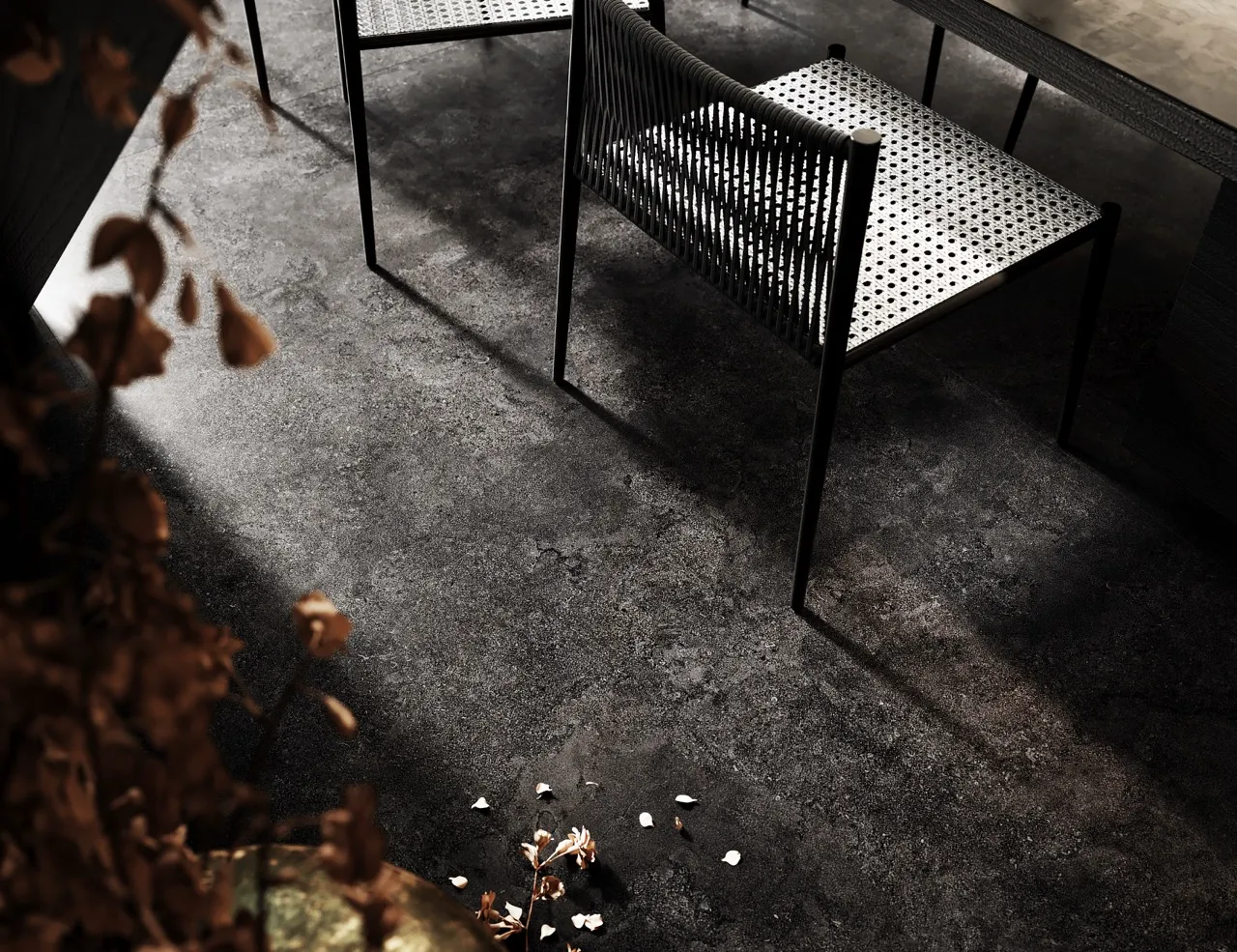 Black limestone look sintered stone flooring in modern dining and hospitality space