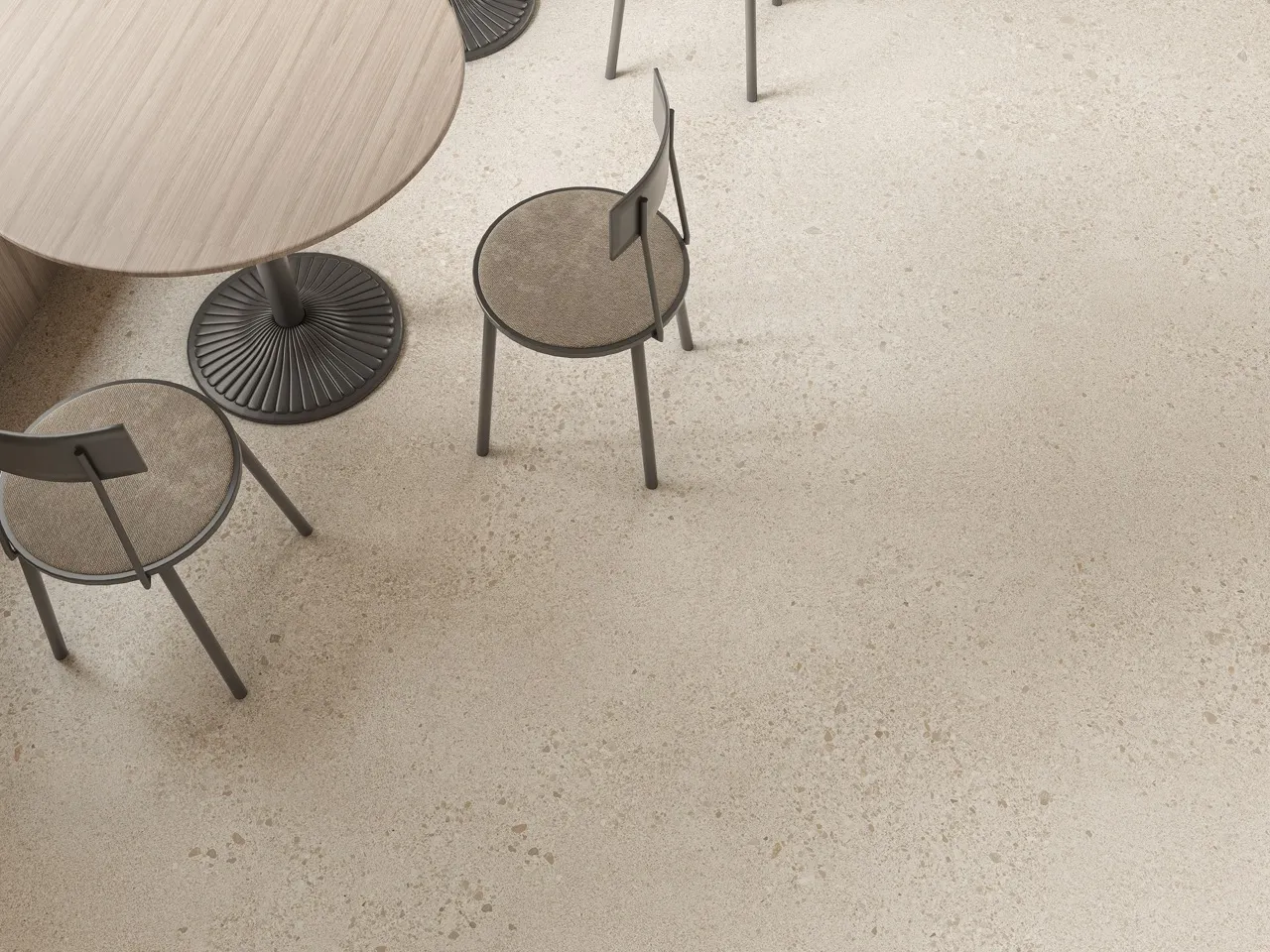 Detail view of gray white terrazzo look sintered stone flooring used in a modern commercial interior with matte glazed finish.