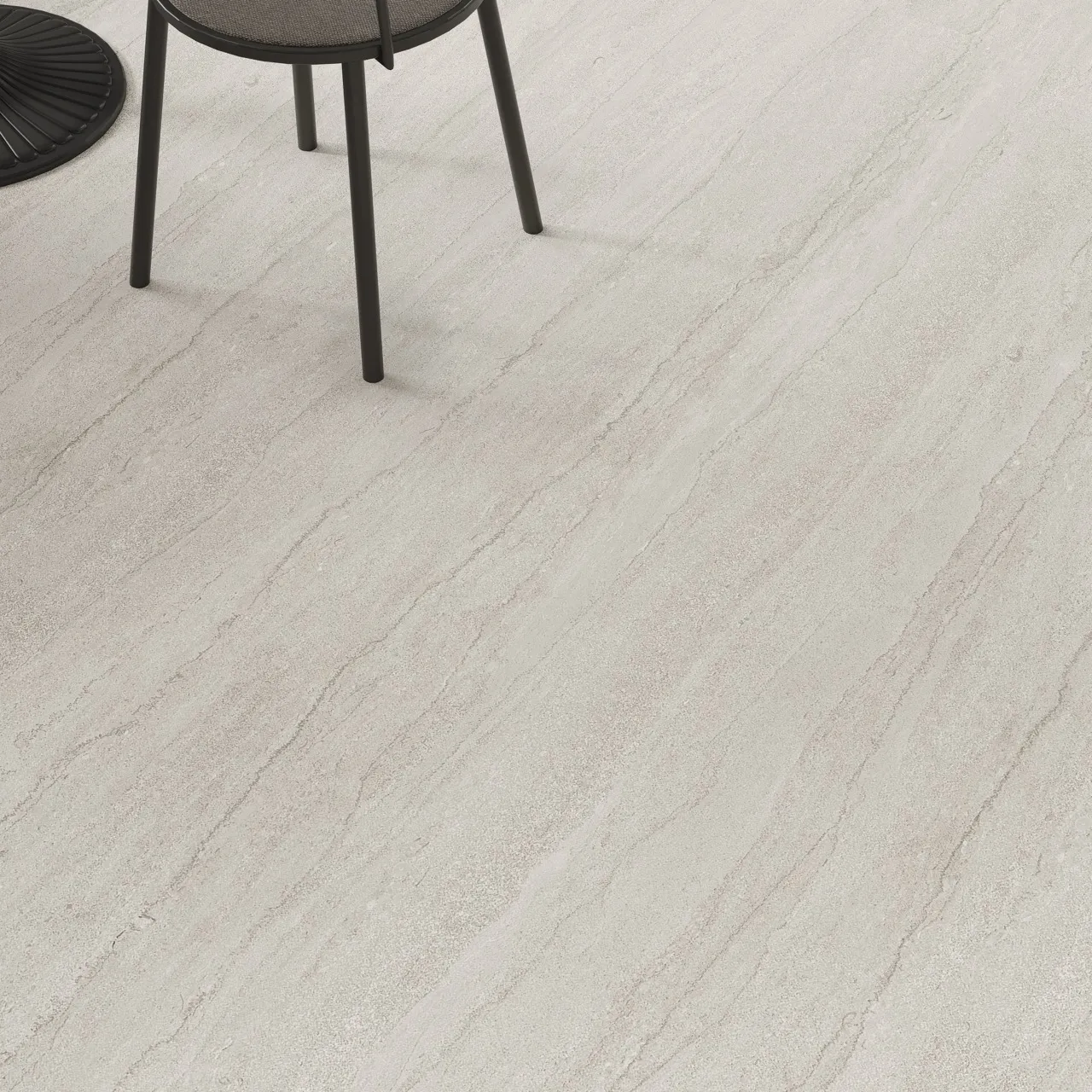 Gray travertine look sintered stone flooring installed in a contemporary laundry room and living space.