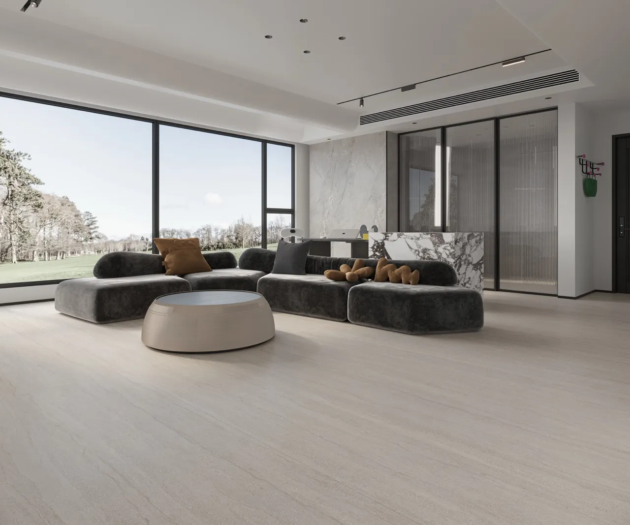 Gray travertine look sintered stone floor in a modern living room with minimalist furniture and expansive windows.