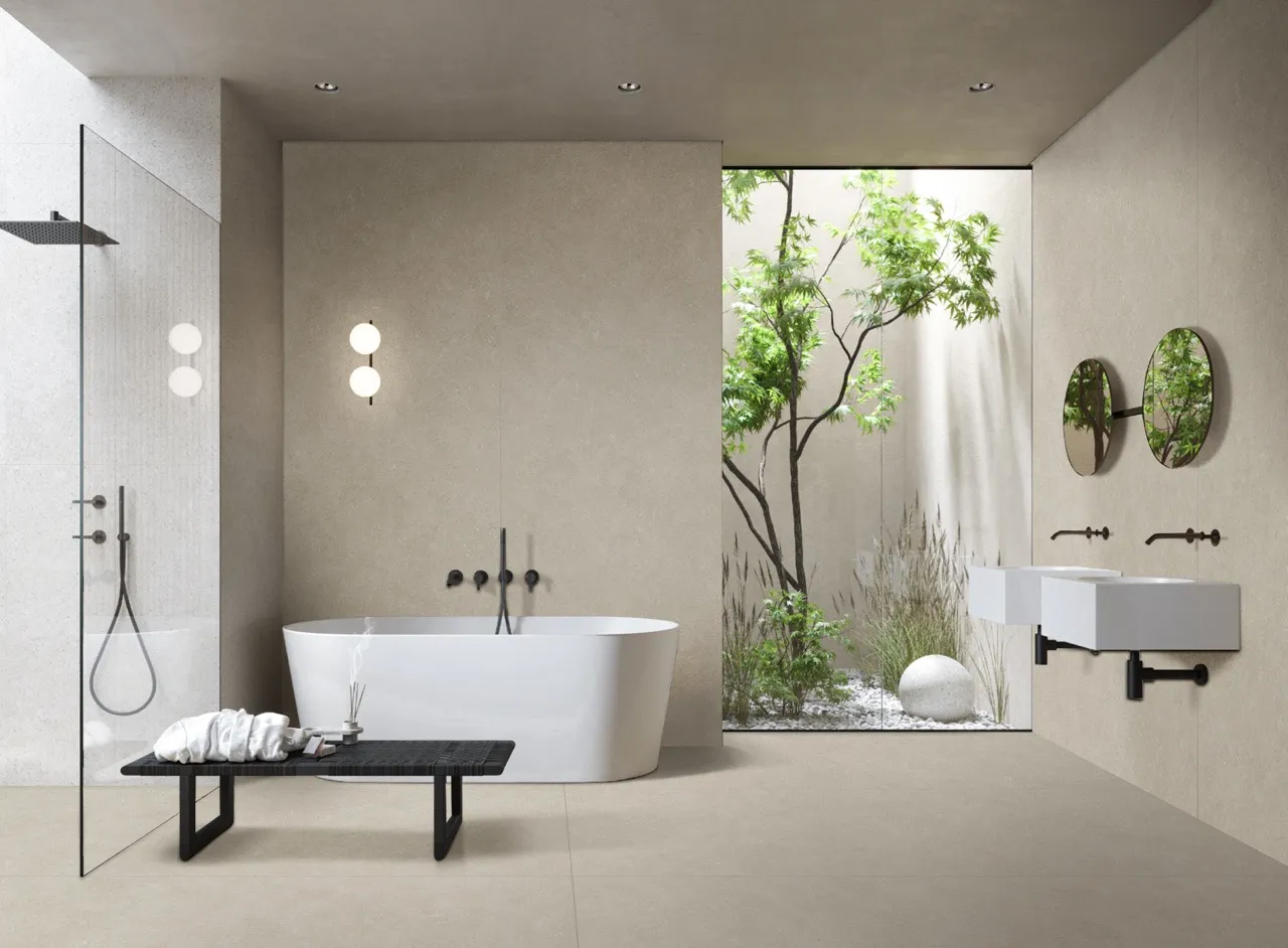 Modern bathroom featuring warm gray limestone look sintered stone on walls and floors