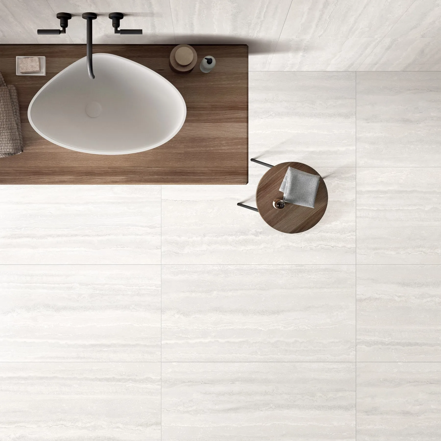 Bathroom interior with white travertine look porcelain tiles installed on the floor, showing soft beige veining and a clean stone effect.