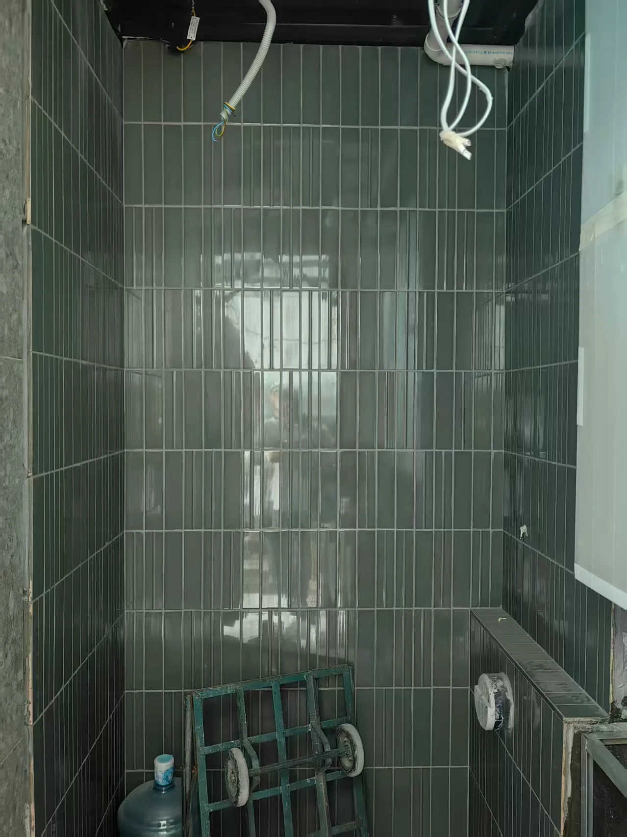 60×253 mm glossy green ceramic tiles installed vertically on interior walls at the Sha Tin residential project.