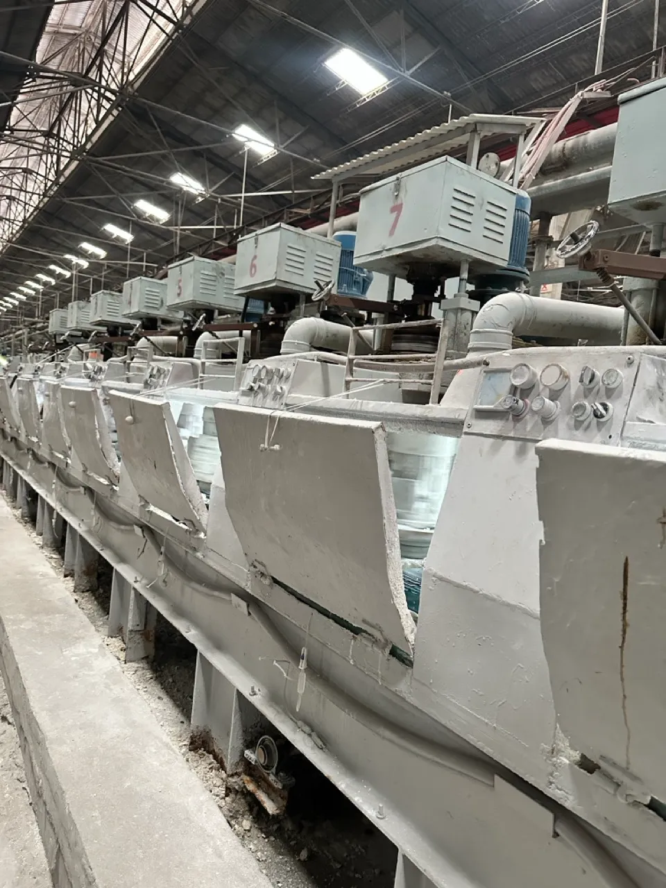 Industrial ceramic tile polishing and surface-finishing equipment operating at an Orizzon partner factory.