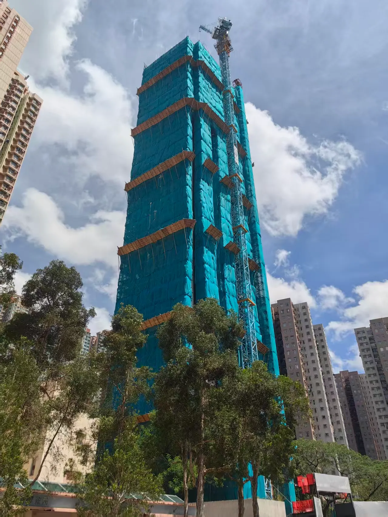 Wide exterior view of the high-rise UNI Residence project under construction in Sha Tin, Hong Kong.