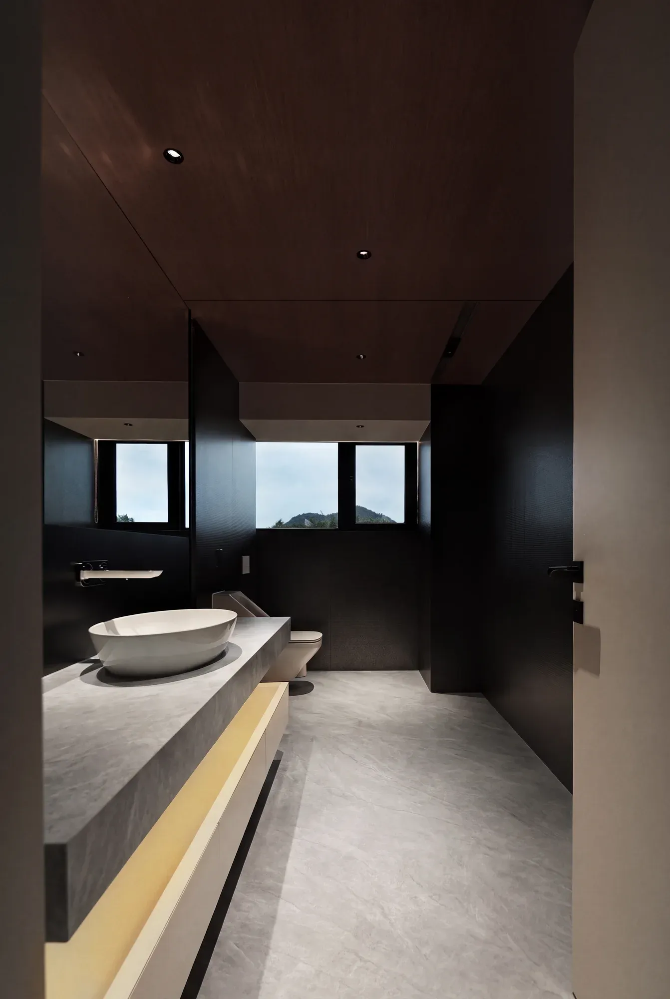Taj Mahal gray white sintered stone used in a dark bathroom floor